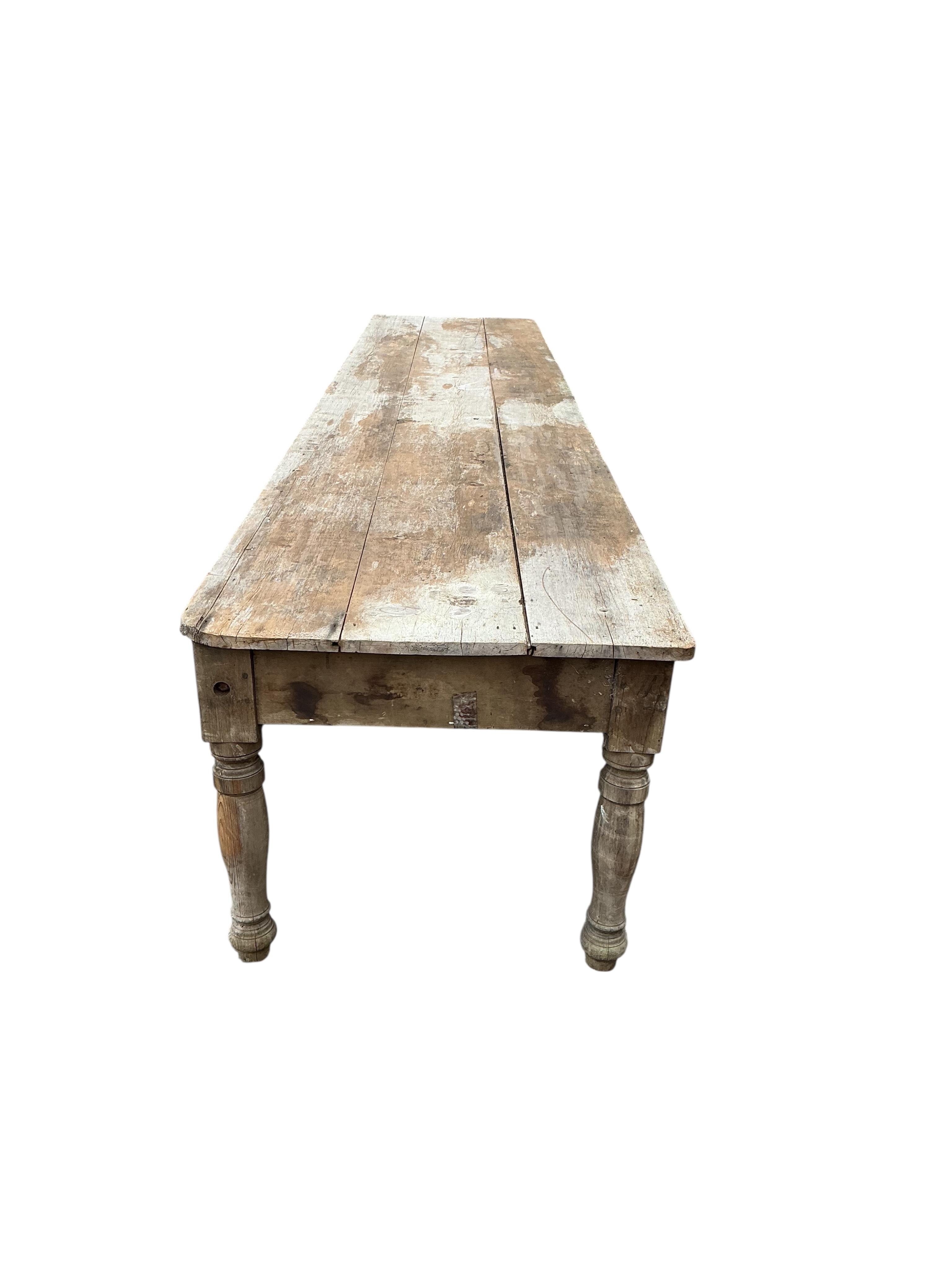 A long Victorian pine laundry table, length 600cm, width 104cm, height 86cm